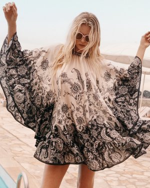 A swirl of paisley, a play on movement.The Rhiannon Lantern Mini Dress is now available in sto...jpg