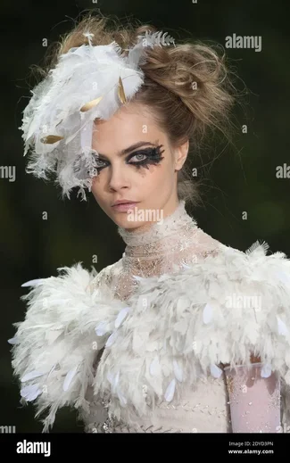 cara-delevingne-displays-a-creation-by-karl-lagerfeld-for-chanels-spring-summer-2013-haute-co...webp