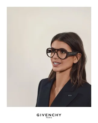 Kaia Gerber wears the double-breasted jacket in black wool mohair and the bold glasses from t...webp