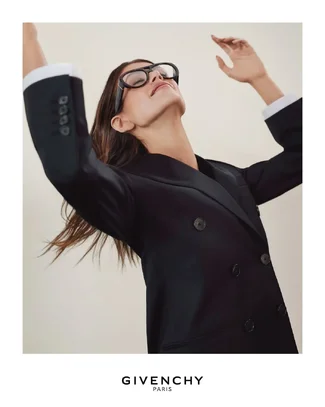 Kaia Gerber wears the double-breasted jacket in black wool mohair and the bold glasses from t...webp