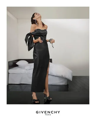 Kaia wears the bow bustier dress in black leather with deconstructed crystal jewellery and bo...webp