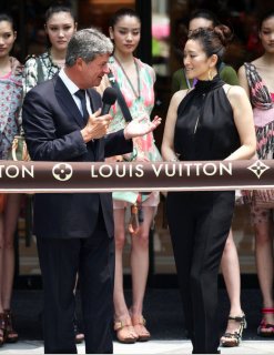 Gong Li Yves Carcelle CEO   Louis Vuitton Shanghai 3 in back.jpg